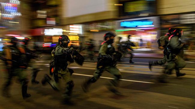 Police charge towards protesters in Hong Kong. Picture: AFP