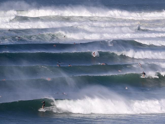 Surfers are seen riding waves at Kirra on the Gold Coast , Friday, February 22, 2019.  Huge swells and high tides are pummelling south-east Queensland beaches as Cyclone Oma sits off the Queensland coast. (AAP Image/Dave Hunt)