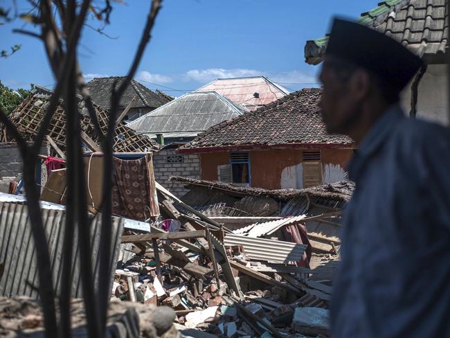 An Indonesian man inspects the damage in a village from a major earthquake in Kayangan on Lombok. Picture: AP