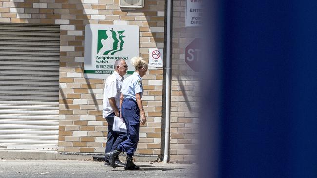 Orkopoulos with a police officer at Maroubra Police station today. Picture: Damian Shaw