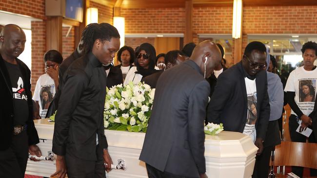 Pallbearers carry the coffin at Anong Luk’s funeral.