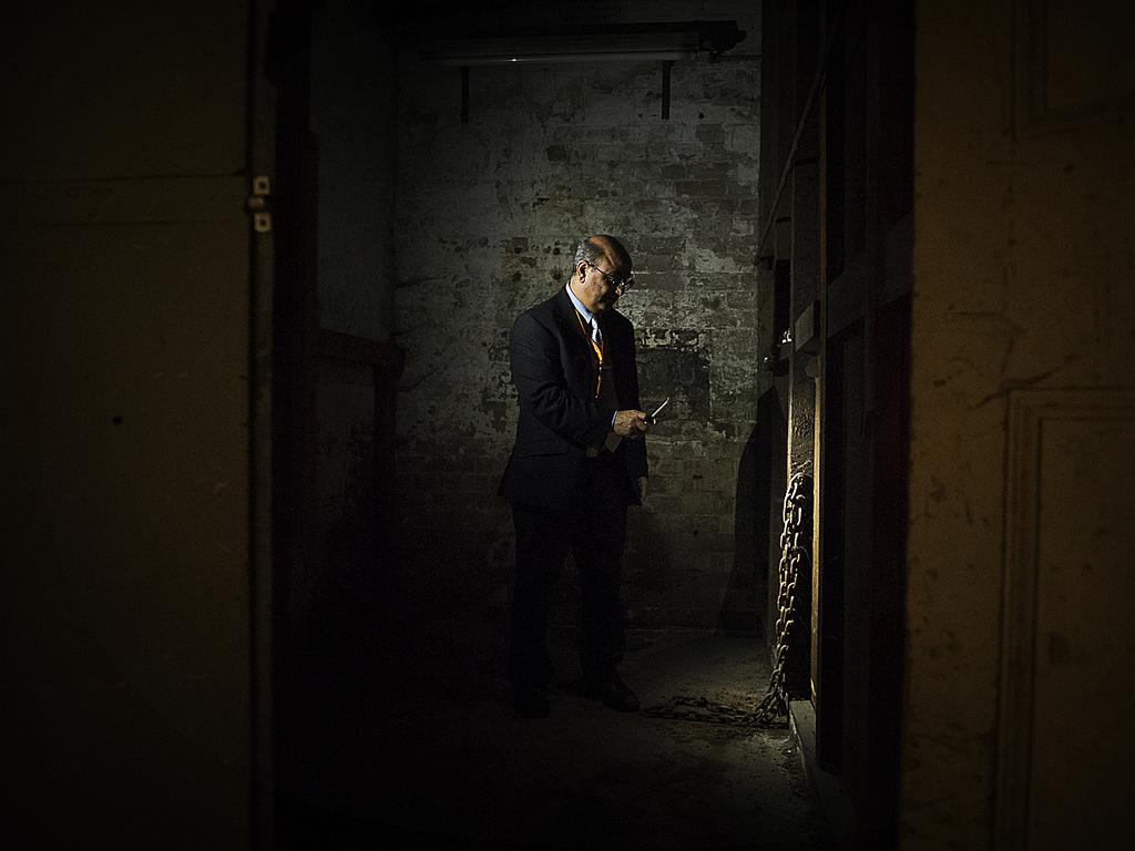 Tony Eid, Director of Operations for Sydney Trains, stands in a disused gaol cell under Central Station beside chains used to shackle prisoners. Photos: Chris McKeen