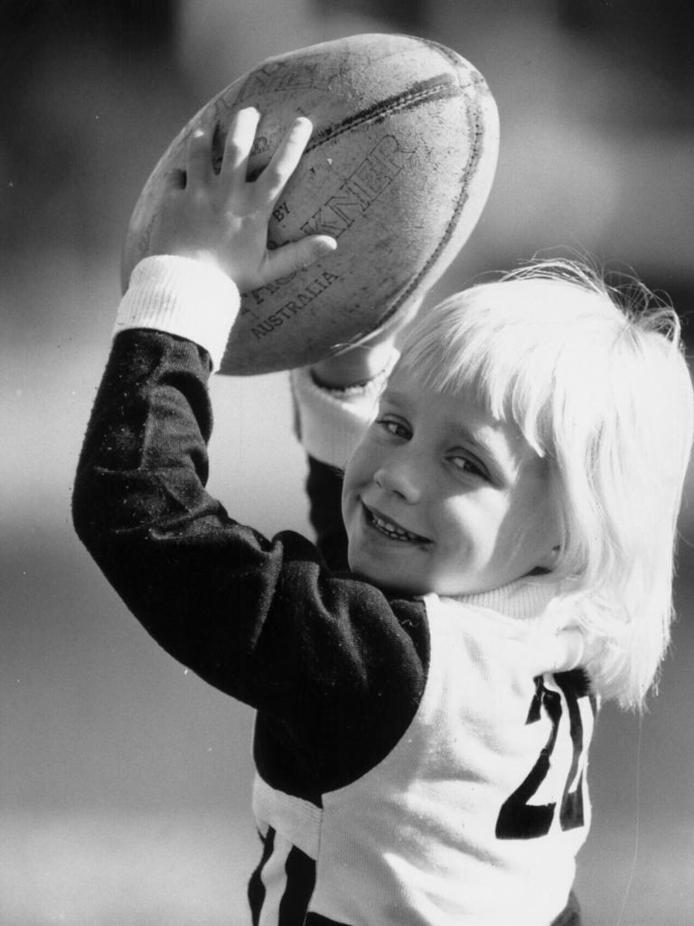 Erin Phillips holding a football, aged 5. Picture: Phil Hillyard