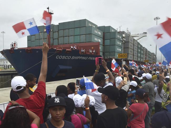 TOPSHOT - Chinese-chartered merchant ship Cosco Shipping Panama crosses the new Agua Clara Locks during the inauguration of the expansion of the Panama Canal in Colon, 80 km from Panama City on June 26, 2016 on June 26, 2016. A giant Chinese-chartered freighter nudged its way into the expanded Panama Canal on Sunday to mark the completion of nearly a decade of work forecast to boost global trade. / AFP PHOTO / RODRIGO ARANGUA