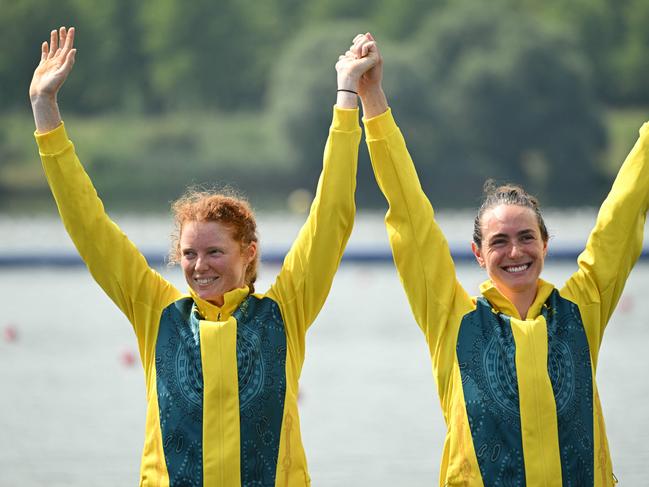 Australia's bronze medallists Annabelle Mcintyre and Jess Morrison celebrate on the podium during the medal ceremony after the women's pair final rowing competition at Vaires-sur-Marne Nautical Centre in Vaires-sur-Marne during the Paris 2024 Olympic Games on August 2, 2024. (Photo by Bertrand GUAY / AFP)