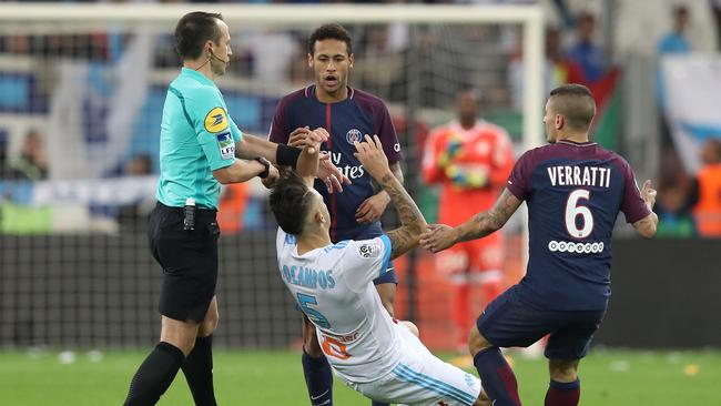 Marseille's Argentinian forward Lucas Ocampos (down) falls after an altercation with Neymar.