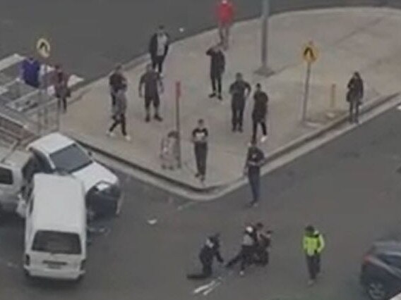 The man in seen attempting to resist arrest while one officer is on the ground. Source: The Daily Telegraph