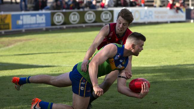 Golden Grove’s Michael Walters tackled by Flinders Park’s in the grand final. The Kookaburras and Reds both look like contenders once again this season. Picture: Emma Brasier