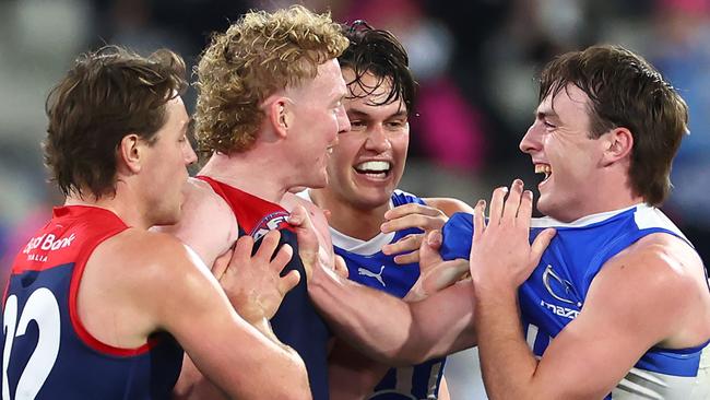 MELBOURNE, AUSTRALIA - JUNE 22:  Clayton Oliver of the Demons and George Wardlaw of the Kangaroos wrestle during the round 15 AFL match between Melbourne Demons and North Melbourne Kangaroos at Melbourne Cricket Ground, on June 22, 2024, in Melbourne, Australia. (Photo by Quinn Rooney/Getty Images)