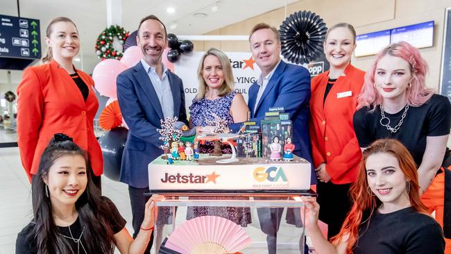 Jetstar CEO Gareth Evans, Queensland Tourism Minister Kate Jones and Queensland Airports Limited CEO Chris Mills, flanked by Jetstar crew and members of P4Pero K-POP Dance group, prepare to cut the celebratory cake to mark the start of the first direct flights between the Gold Coast and Seoul. Picture: Luke Marsden