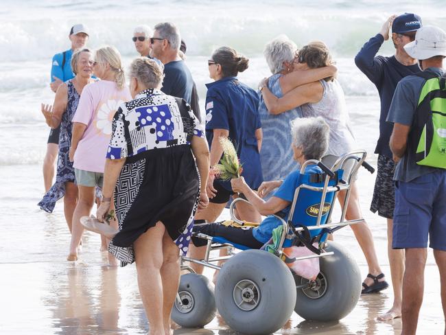 Bribie Island locals gather to pay respects to 17 year old shark attack victim Charlie Zmuda at Woorim Beach on Tuesday morning. Picture Lachie Millard