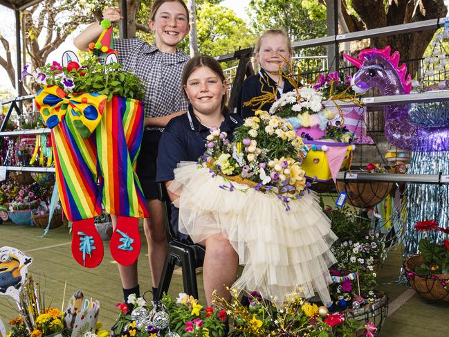 At the Toowoomba East State School hanging basket display are students (from left) Grace Simpson (holding winning student entry by Carter Simpson), Addyson Riddle (holding winning adult entry by Lydia Wade) and Matilda McGaw, Friday, September 13, 2024. Picture: Kevin Farmer