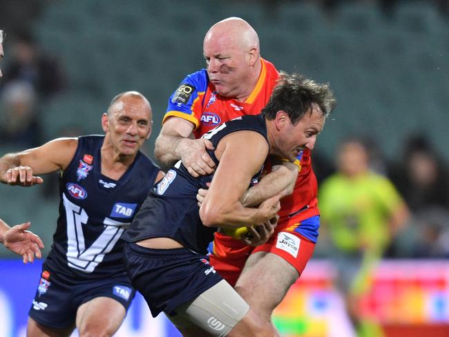 Andrew Jarman from the All Stars tackles Jude Bolton from Victoria during the AFL EJ Whitten Legends match between the All Stars and Victoria at Adelaide Oval in Adelaide, Friday, August 31, 2018. (AAP Image/David Mariuz) NO ARCHIVING, EDITORIAL USE ONLY