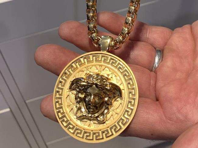 Disappointed Le Style shop owner Steven Adigrati models the type of Versace necklace which was stolen in the elaborate fishing rod heist.