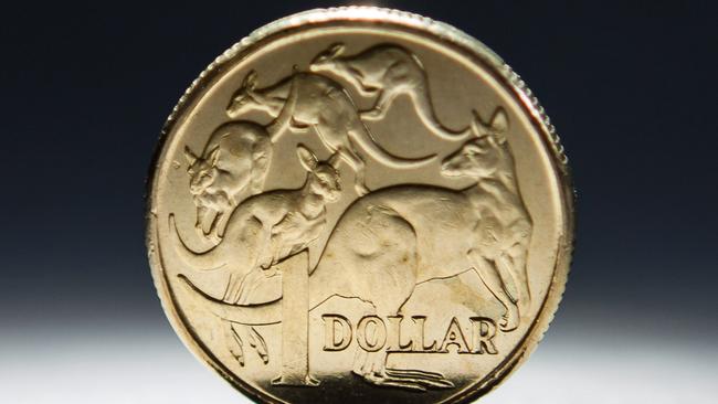 An Australian one-dollar coin is arranged for a photograph in Sydney, Australia, on Wednesday, April 17, 2013. Direct trading between the Australian dollar and yuan started on April 10. Photographer: Ian Waldie/Bloomberg