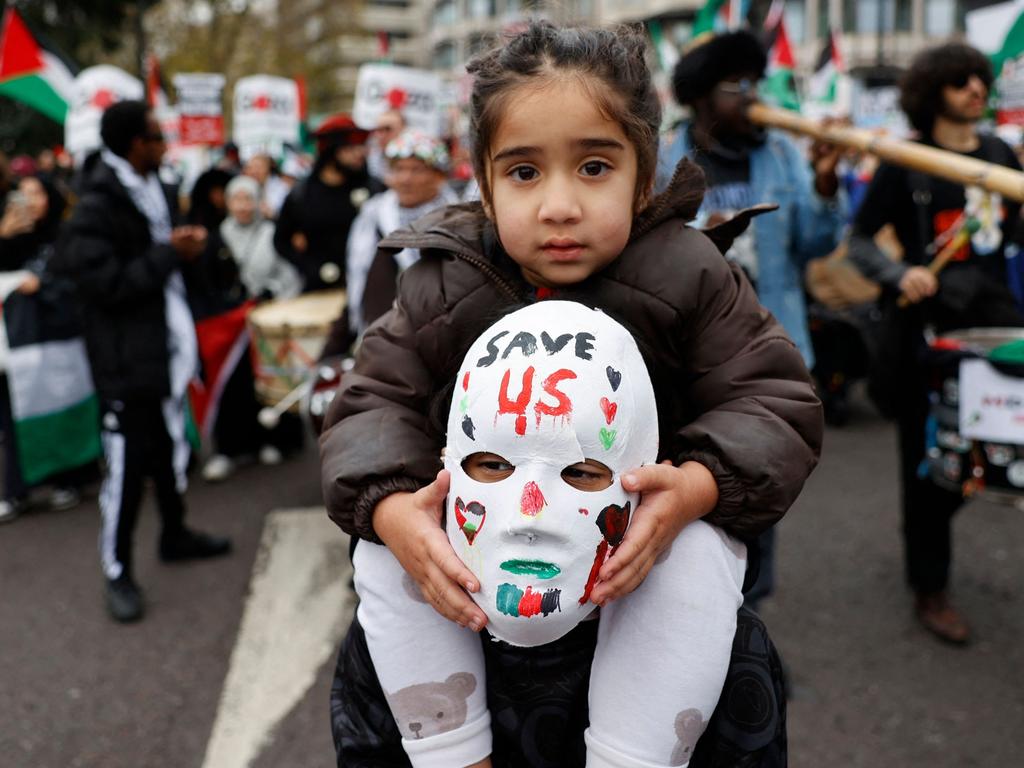 A child is given a ride by a protester during a national demonstration for Palestine and Lebanon, in central London. Picture: Carlos Jasso/AFP