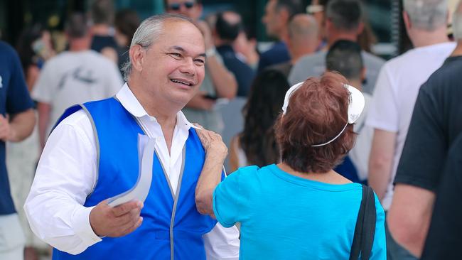 Mayor Tom hands out how to vote material at the Bundall polling booth at the council chambers. Picture: Glenn Campbell