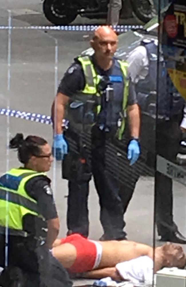 Four people are dead and at least 20 injured after the driver, pictured in red underpants as he is arrested, mounted a footpath at speed and hit bystanders in Melbourne’s CBD. Picture: AAP