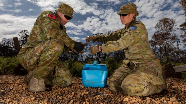 Lance Bombardier Carina Mangini (right) and Gunner Nathan Summers collect undamaged wire fencing turnbuckles at a campsite in the Flinders Chase National Park. Picture: ADF