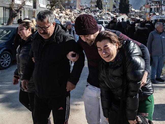 People mourn in front of a collapsed building in Hatay, Turkey. Picture: Getty Images