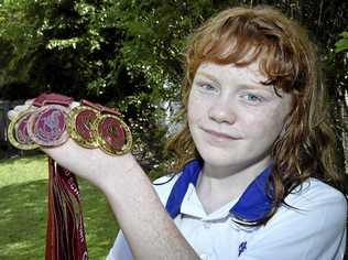 ATHLETIC STAR: Megan Seipel, 11, proudly shows off the medals she won at last weekend's 10-12 years Track and Field State Championships in Cairns. Picture: Bev Lacey