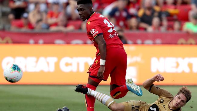 Adelaide United’s Al Hassan Toure tackled by Western Sydney’s Pirmin Schwegler at Coopers Stadium on Friday. (AAP Image/James Elsby)