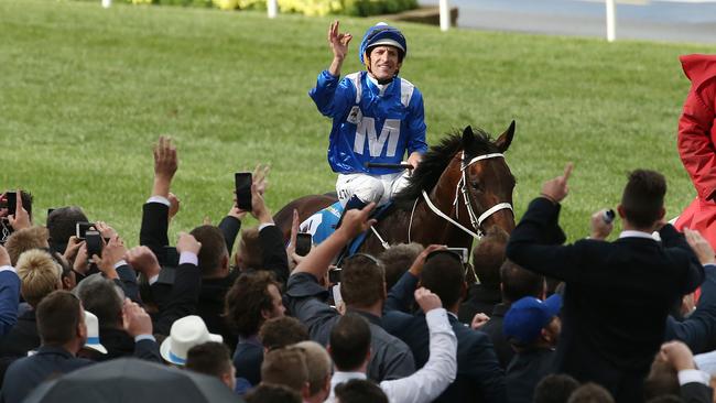 The crowd rises to salute Winx and Hugh Bowman after the mare’s breathtaking win. Picture: Colleen Petch