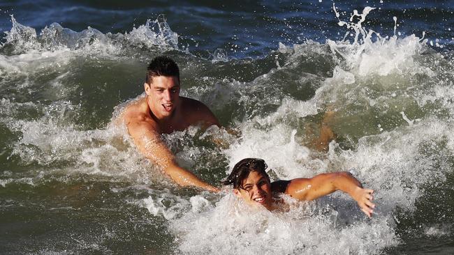 Matthew Kruezer, left, in the surf at Carlton’s preseason camp. Can he top the SuperCoach ruck stocks for the second year in a row? Picture: Michael Klein