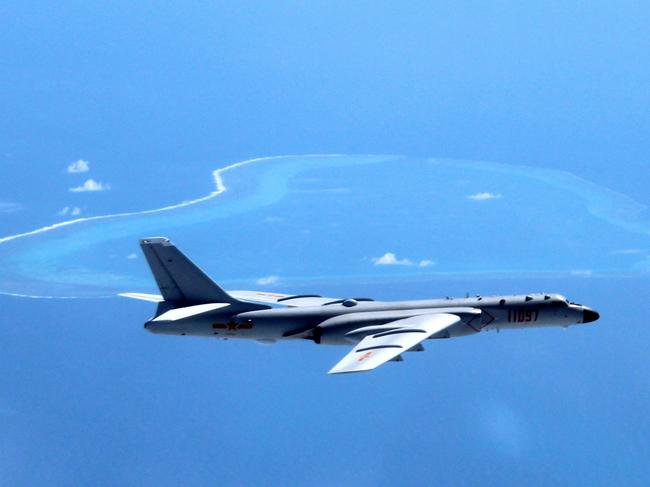 FILE - In this undated photo released by Xinhua News Agency, a Chinese H-6K bomber patrols the islands and reefs in the South China Sea. Chinaâ€™s state broadcaster showed on Sunday, May 7, 2017, navy fighter bombers taking part in exercises over the South China Sea, including one involving the detection and expulsion of foreign military surveillance aircraft such as those deployed regularly in the area by the U.S. and others. The video shown on CCTVâ€™s military channel shows a squadron of two-seater Xian JH-7 Flying Leopards flying in formation and dropping bombs on targets in the ocean below. (Liu Rui/Xinhua via AP, File)