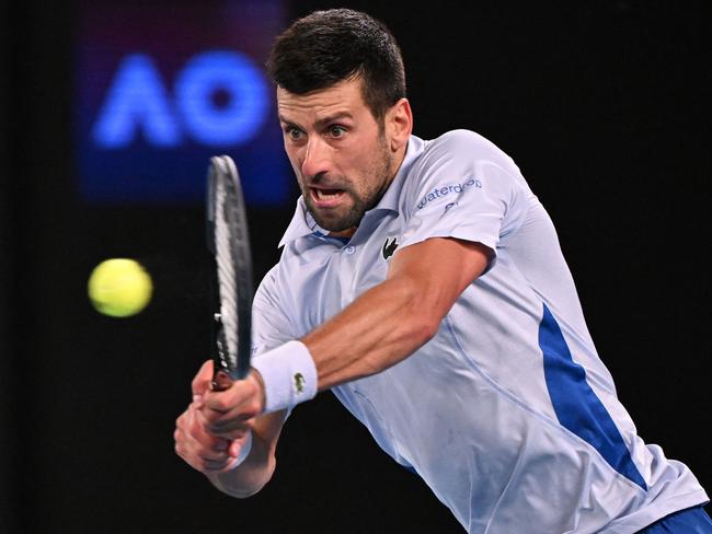 Serbia's Novak Djokovic hits a return against Croatia's Dino Prizmic during their men's singles match on day one of the Australian Open tennis tournament in Melbourne on January 14, 2024. (Photo by WILLIAM WEST / AFP) / -- IMAGE RESTRICTED TO EDITORIAL USE - STRICTLY NO COMMERCIAL USE --