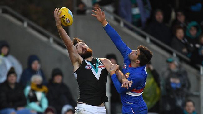 Port power forward Charlie Dixon takes a grab over Marcus Adams of the Bulldogs. Picture: AAP Image/Julian Smith