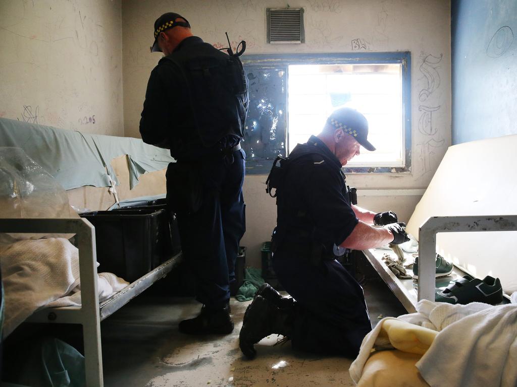 Corrective Services officers raid cells at Silverwater Jail looking for contraband. The officers now wear body cams that record the raids. Picture: Richard Dobson