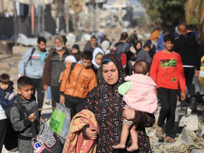 Palestinians fleeing the fighting in war-torn Gaza walk on Salaheddine road in the Zeitoun district of the southern part of the Gaza Strip. Picture: AFP