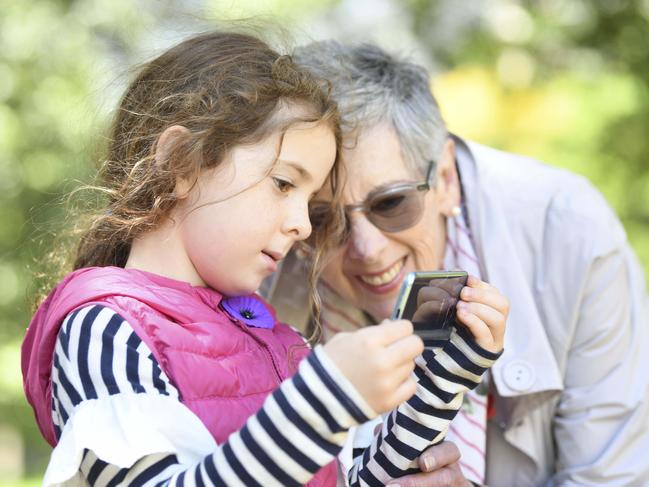 Maggie Johnson, the granddaughter of famous WW1 nurse Alice Ross-King, and her own granddaughter Emily Schranz test ANZAC 360 on a phone. Picture: Darren Leigh Roberts