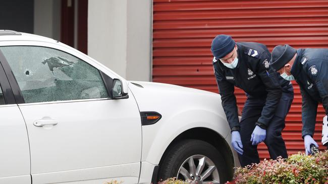 Bullet holes can be seen in the car window. Picture: David Crosling