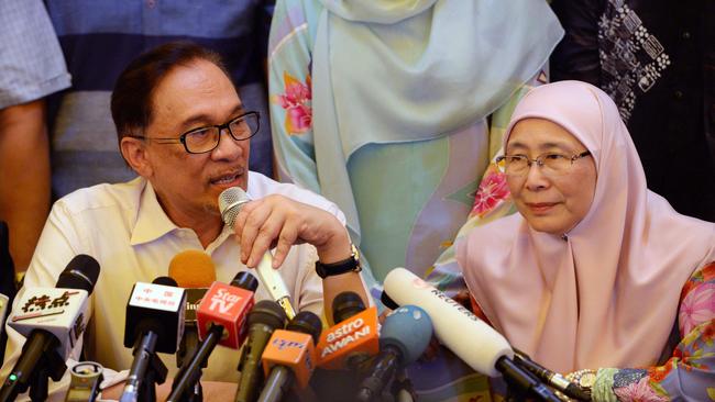 Anwar Ibrahim speaks to the media yesterday with his wife Wan Aziza Wan Ismail at his side. Picture: AFP