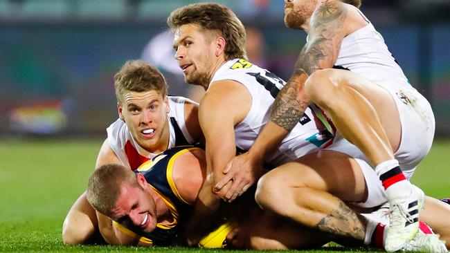 Adelaide’s Andrew McPherson is tackled by three St Kilda players at Adelaide Oval