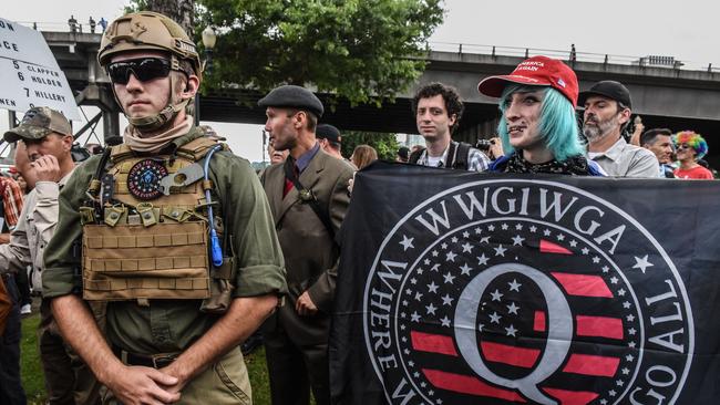 A QAnon follower person holds the group’s banner during an alt-right rally in Portland, Oregon. Picture; AFP.