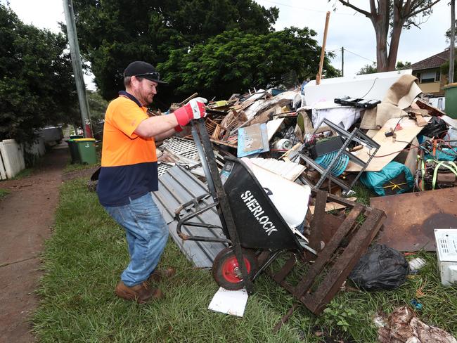 Resident Arron Gerrey cleaning up on Diadem St in Lismore in the aftermath of the devastating floods. Picture: Jason O'Brien