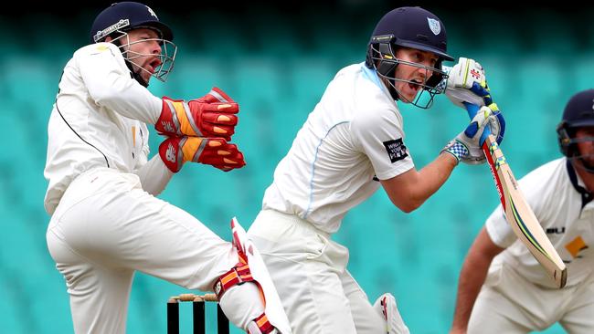 Peter Nevill bats as his Test replacement Matthew Wade looks on. Picture: Gregg Porteous