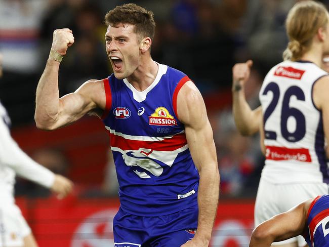 MELBOURNE, AUSTRALIA - AUGUST 06: Josh Dunkley of the Bulldogs celebrates kicking a goal during the round 21 AFL match between the Western Bulldogs and the Fremantle Dockers at Marvel Stadium on August 06, 2022 in Melbourne, Australia. (Photo by Daniel Pockett/Getty Images)