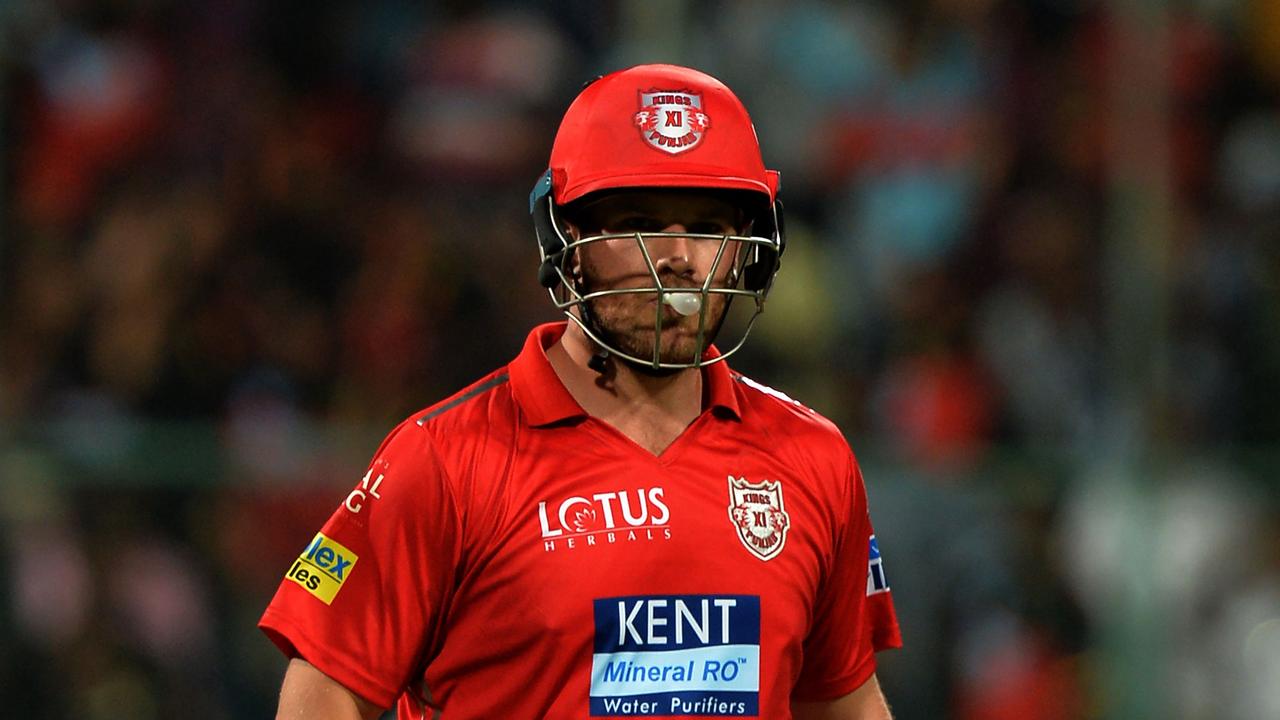 Kings XI Punjab batsman Aaron Finch walks back to the pavilion after being dismissed leg before for zero runs during the 2018 Indian Premier League (IPL) Twenty20 cricket match between Royal Challengers Bangalore and Kings XI Punjab at the M. Chinnaswamy Stadium in Bangalore on April 13, 2018. / AFP PHOTO / Manjunath KIRAN / ----IMAGE RESTRICTED TO EDITORIAL USE - STRICTLY NO COMMERCIAL USE----- / GETTYOUT