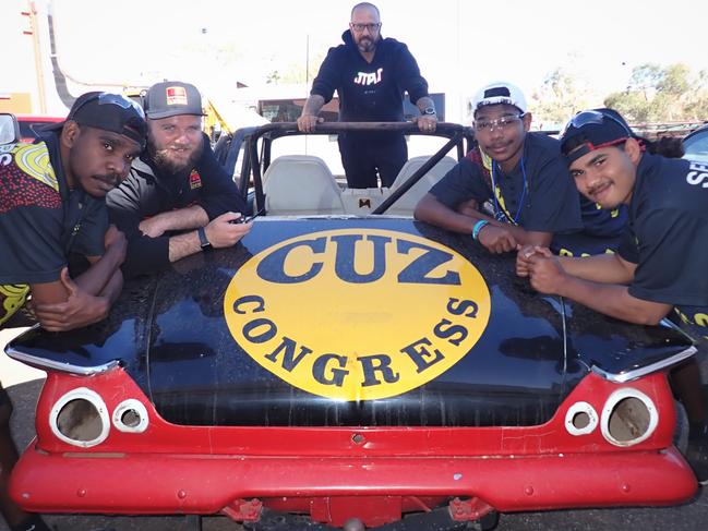 First Nations men from Yirara College engaged in work to restore a 1960s âCuz Congressâ Valiant at CDU in Alice Springs. Picture: Charles Darwin University