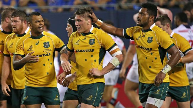 CHICAGO, IL - SEPTEMBER 05: Sean McMahon #7 of the Australia Wallabies (center) is congratulated by teammates after scoring a try against the United States Eagles during a match at Soldier Field on September 5, 2015 in Chicago, Illinois. Australia defeated the United States 47-10. Jonathan Daniel/Getty Images/AFP == FOR NEWSPAPERS, INTERNET, TELCOS & TELEVISION USE ONLY ==