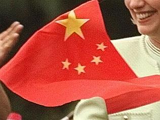 30Jun98. First lady Hillary Rodham Clinton smiles as she walks past a line of Chinese students waving Chinese and American f...