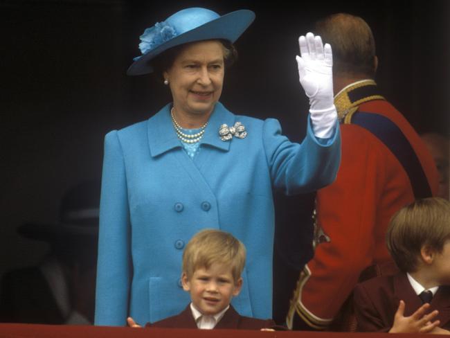 Prince Harry watches with his grandmother from the balcony of Buckingham Palace in 1988. Picture: John Shelley/Getty