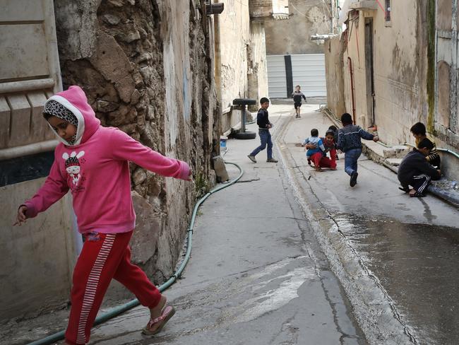 Kids play in the streets of Mosul Old City. Picture: Ella Pellegrini