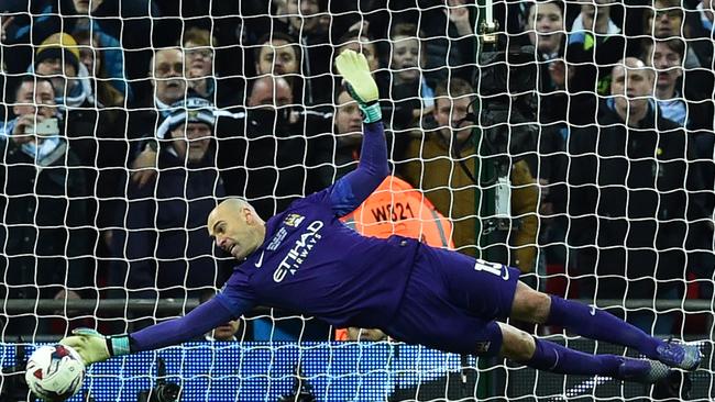 Manchester CIty's Argentinian goalkeeper Willy Caballero (L) saves.