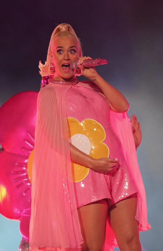 A pregnant Katy Perry cups her baby bump on stage. Picture: AAP Image/Scott Barbour