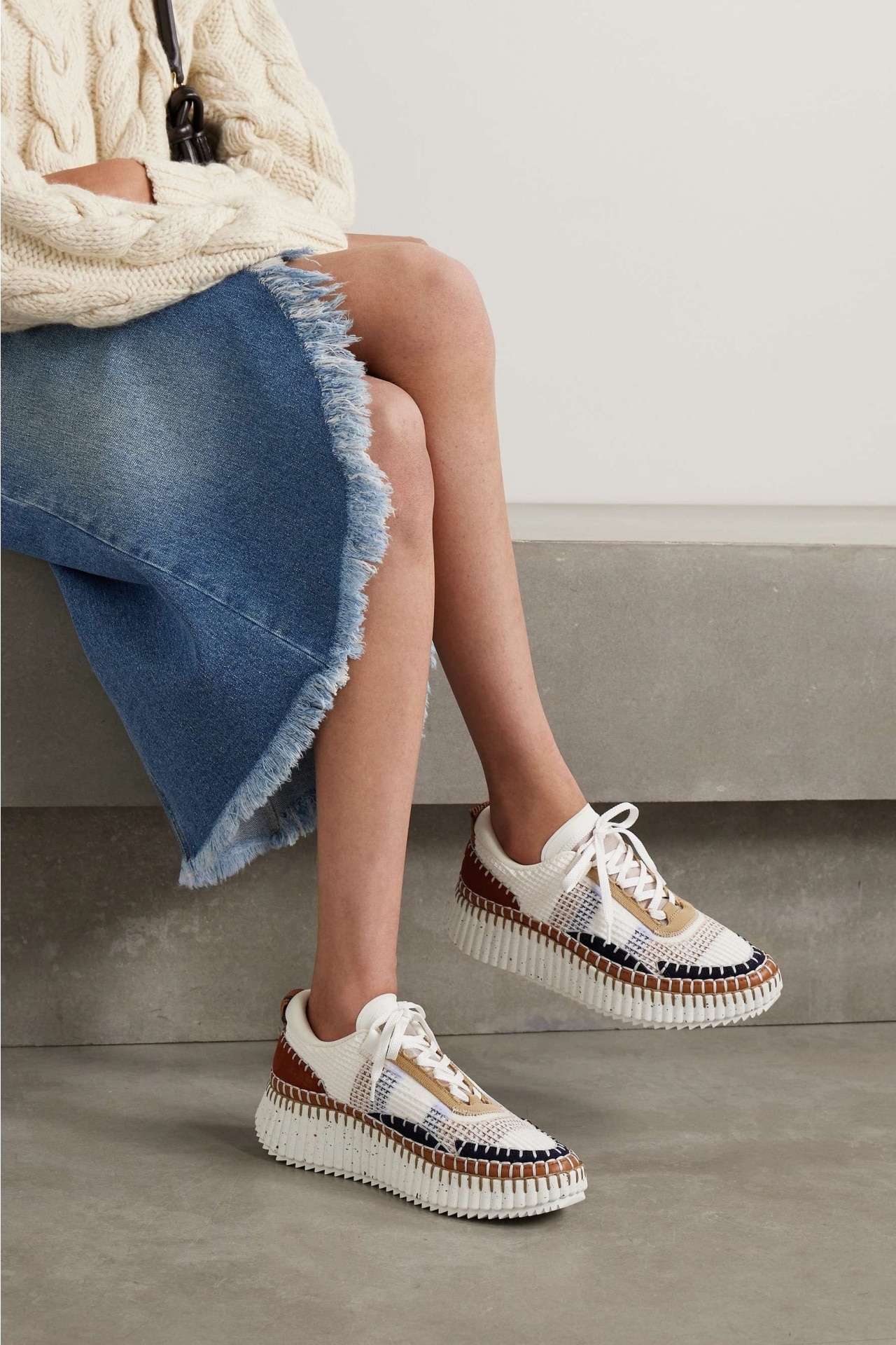 <h3><a href="https://www.net-a-porter.com/en-au/shop/designer/chloe" target="_blank" rel="nofollow noopener"><b>Chlo&eacute;</b></a></h3><p><strong>Nama embroidered suede and recycled mesh sneakers</strong></p><p>Multi-coloured thread and a chunky sole set this Chlo&eacute; sneaker apart from the rest&mdash;the definition of a statement sneaker.</p><p><b>Material: </b>Suede and recycled mesh | <b>Colour range: </b>Burgandy, white, beige, blue, black | <b>Type: </b>Low-top sneaker | <b>Delivery:</b> $10 express shipping</p><p class="button-common"><a title="SHOP NOW FOR $1290" href="https://www.net-a-porter.com/en-au/shop/product/chloe/shoes/low-top/plus-net-sustain-nama-embroidered-suede-and-recycled-mesh-sneakers/1647597326120967" target="_blank" data-cta="SHOP NOW FOR $1290" data-editable="true">SHOP NOW FOR $1290</a></p>